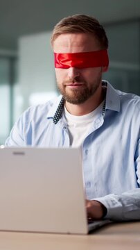 Blindfolded Businessman Struggling With Computer