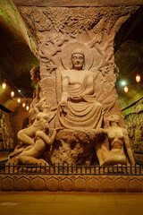 Sculpture of Gautama Buddha surrounded by voluptuous women, underground palace, Oriental Buddha Park, Leshan city, Sichuan, China, Asia © Tolo