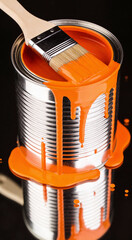 Close-up of metal paint can filled with bright orange paint, with brush resting on top and dripping streaks. Perfect for art, DIY, or creative project visuals