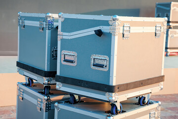 Heavy duty road cases with wheels providing secure protection for musical or light stage equipment during transport and storage outdoors