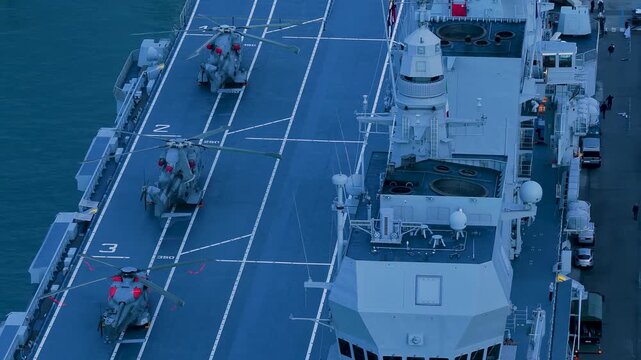 Aerial view of helicopters positioned on the flight deck of the Cavour ship, highlighting its massive structure near the port, Trieste, Friuli-Venezia Giulia, Italy.