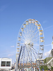 Fototapeta premium Giant Ferris Wheel Over Sunny Pier