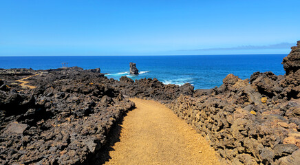 Volcanic rock path winding along west coast of Island El Hierro, Canary Islands, Spain, Europe.