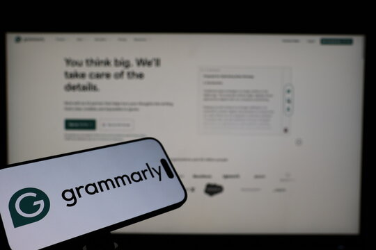 Kiel, Germany - 02-04-2026: Smartphone displaying US writing assistant software company Grammarly logo in front of companys webpage