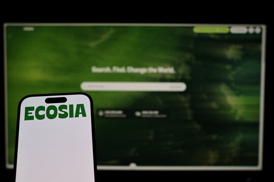 Kiel, Germany - 02-04-2026: Smartphone displaying German search engine company Ecosia logo in front of companys webpage