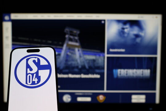 Kiel, Germany - 02-04-2026: Smartphone displaying German football club FC Schalke 04 logo in front of companys webpage
