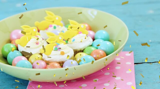 Mint bowl holding cupcakes and eggs, gold confetti falling, lens shifting closer showing treats