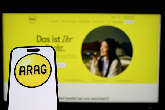 Kiel, Germany - 02-04-2026: Smartphone displaying German insurance company ARAG logo in front of companys webpage