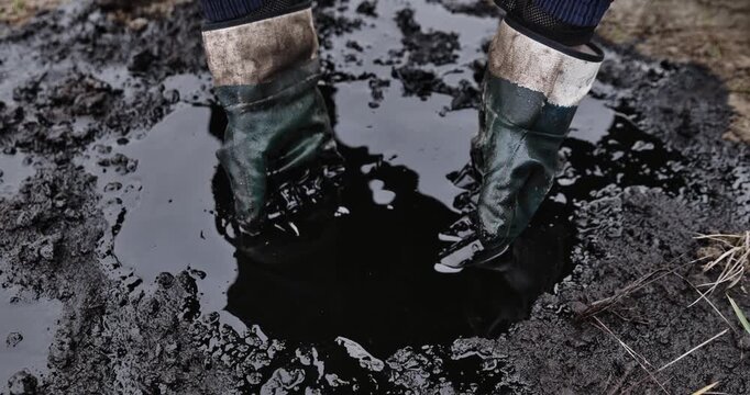 crude oil in hand due to crude oil leak. petrochemical,refinery process,Caucasian hands cupped with black oil when oil spill environmental effect,concept of environmental pollution