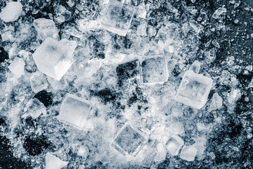 Ice cubes with a ice crush and snow on black background.