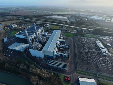 Aerial view of the industrial grandeur of Spalding Power Station emerges, a stark contrast to the serene landscape, Spalding, Spalding, United Kingdom.