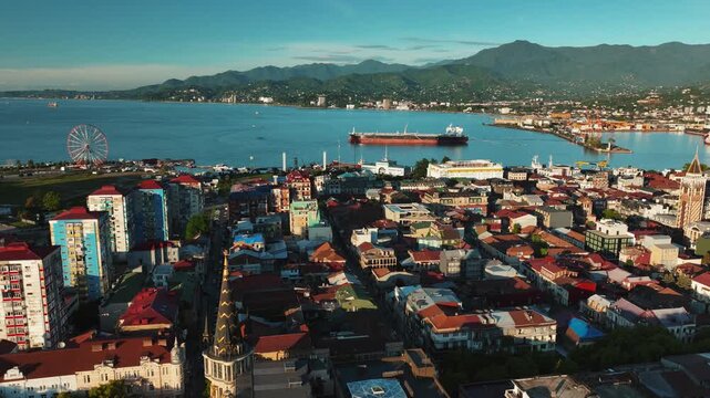Aerial drone footage of Batumi city, Georgia, showcasing modern architecture, Black Sea coastline, city skyline, streets, and urban development. Cinematic cityscape highlighting .