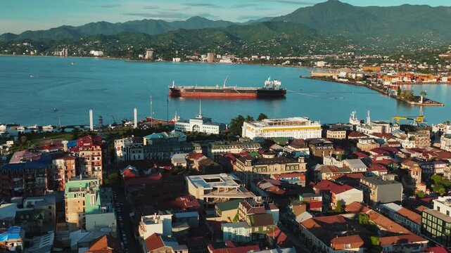 Aerial drone footage of Batumi city, Georgia, showcasing modern architecture, Black Sea coastline, city skyline, streets, and urban development. Cinematic cityscape highlighting .