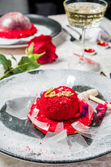 Naklejka premium A vibrant red dessert with a love sign sits elegantly on a romantic table setting