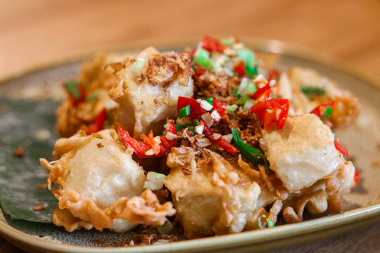 Closeup of crispy tofu infused with aromatic spices (Tahu Crispy Rempah).