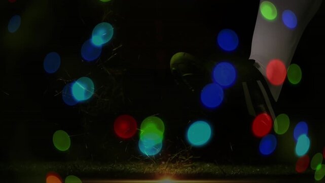 Red rugby ball labeled JAPAN glowing, bokeh moving, cleat entering, kicking ball starting play