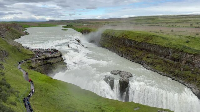 Gullfoss waterfall with flowing waterfall over two steps.