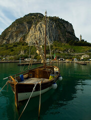 traditional wooden boat, possibly a gozzo, moored in a harbor in Italy, likely near Capri or Cefal&ugrave;. 