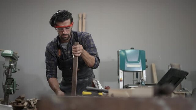 Carpenter is working at workshop. Small business and craft product.