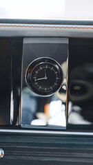 Obraz premium Clock on the dashboard of a luxury car interior showing time during a drive