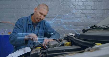 Adjusting mechanic in blue coverall with wrench fastening inside engine bay in garage, with HUD