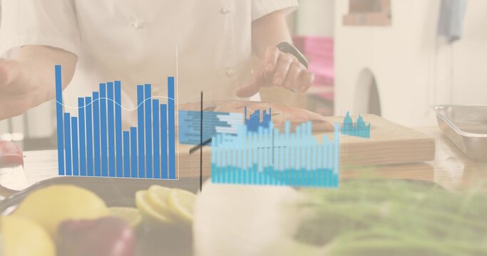 Chopping produce, woman chef in white chef jacket at cutting board, with knife and blue charts