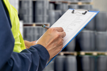 Naklejka premium Hands, engineer and clipboard for checklist, inspection notes or control of barrels of oil. Person,writing with documents for, project management or supervisor paperwork and pen