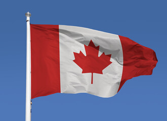 Close-up view of Canada national flag waving in the wind. Portugal is an European country located in western Europe. Blue sky background