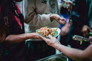 The hands of the hungry are asking for food from the donor