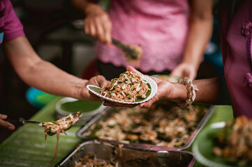 The hand of a beggar received food from a compassionate person, Concept of sharing