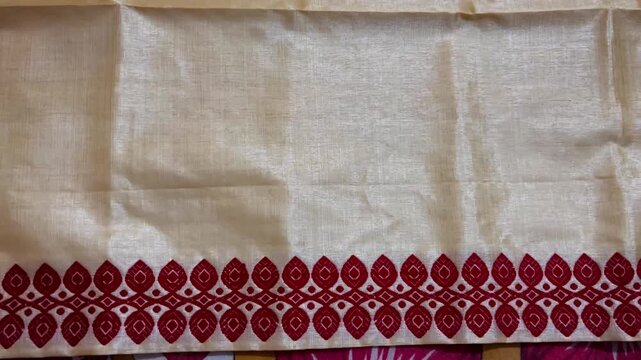 Shot of Assamese Traditional Muga sador of assam , simple pure muga sador , Assam muga silk , golden thread 