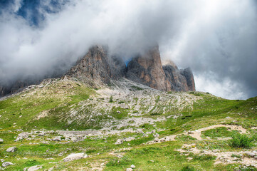 Tre Cime di Lavaredo mountains enveloped by clouds, Dolomites, Italy