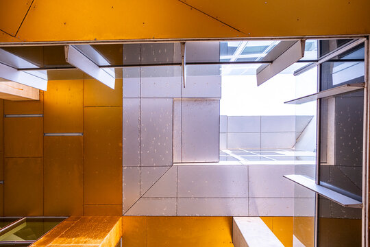 Corporate office architecture interior with atrium geometry and skylight light across ceiling structure creating modern business background for design and finance use
