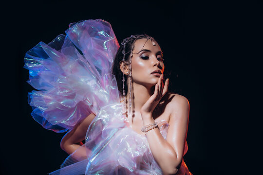 High Fashion art portrait model woman in colorful bright neon lights posing, portrait of beautiful fantasy girl, trendy make-up and holographic tulle, colorful make up,  Vivid makeup