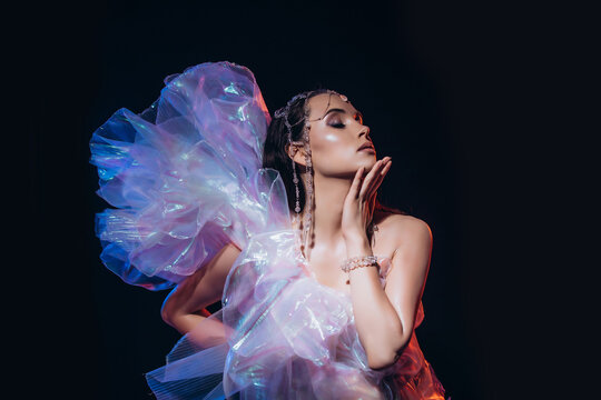 High Fashion art portrait model woman in colorful bright neon lights posing, portrait of beautiful fantasy girl, trendy make-up and holographic tulle, colorful make up,  Vivid makeup
