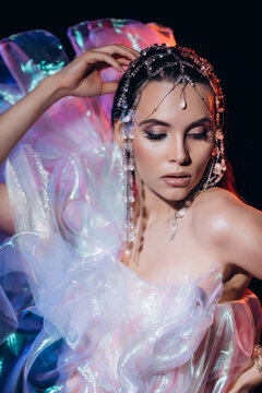 High Fashion art portrait model woman in colorful bright neon lights posing, portrait of beautiful fantasy girl, trendy make-up and holographic tulle, colorful make up,  Vivid makeup
