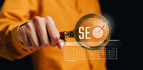 SEO optimization concept. Hand holding magnifying glass with SEO target icon, search engine strategy, keyword analysis, digital marketing performance, online visibility growth.