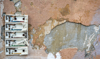 Old broken doorbell on a brick wall in a house