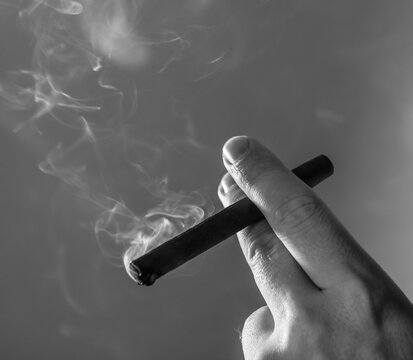 smoking cigarette in hand. Man finger. Smoke. Cigars. Photo. 