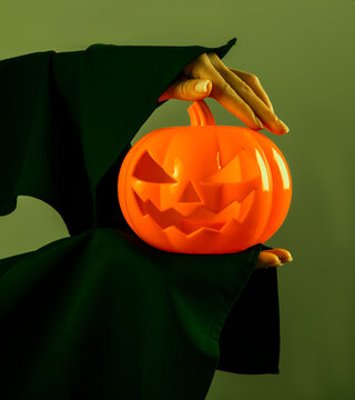 Autumn pumpkins. Halloween concept. Photo. Decoration. Celebration. Holidays. Woman hand with Halloween pumpkin.