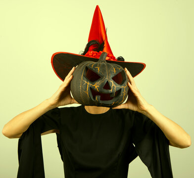 halloween witch with a pumpkin. Halloween photo. People. Horror. Model. Female. Dark. 