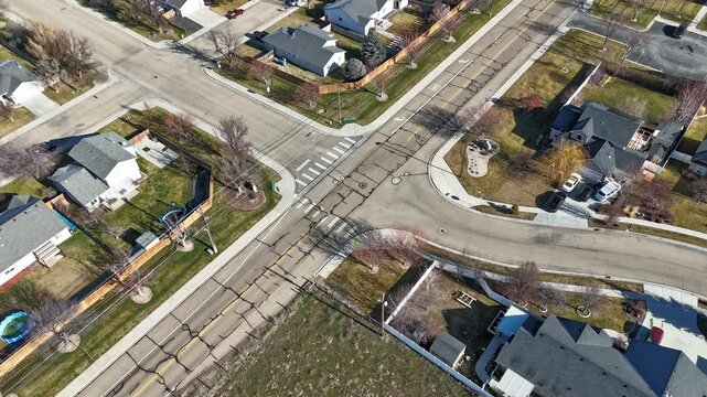 drone timelapse flying over neighborhood street intersection in fall yard fences