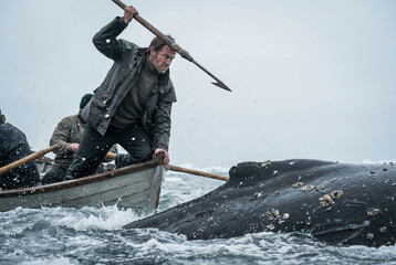 A dramatic historical scene of whalers hunting a massive whale from a wooden boat in a stormy sea. A man poises with a harpoon for a dangerous strike.
