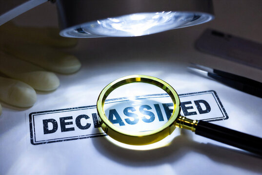 Magnifying glass over declassified document with lighting and tools  