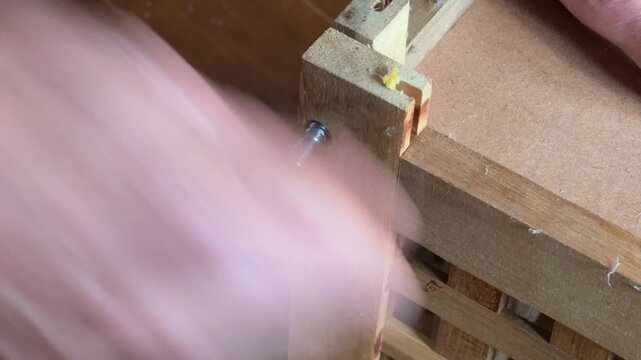Screwing assembling a flat-pack piece of furniture up tight