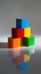 Obraz premium Colorful stacking blocks on a reflective surface in a creative arrangement