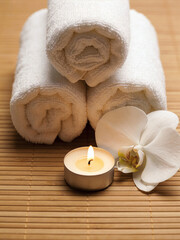 Spa Composition with Rolled Towels and Orchid Flower