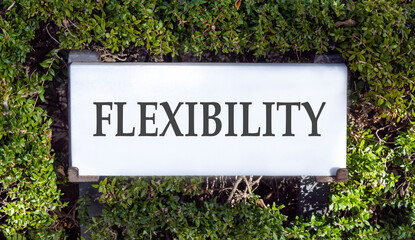 Flexibility symbol. Concept word Flexibility on beautiful white marble sign plate. Beautiful green leaf background. Business flexibility concept. Copy space.