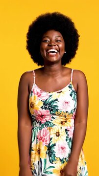 An energetic and happy young African American woman with an afro points directly at the camera, expressing excitement and surprise. Perfect for recrui