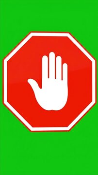 Red stop sign with white hand symbol on green screen background.